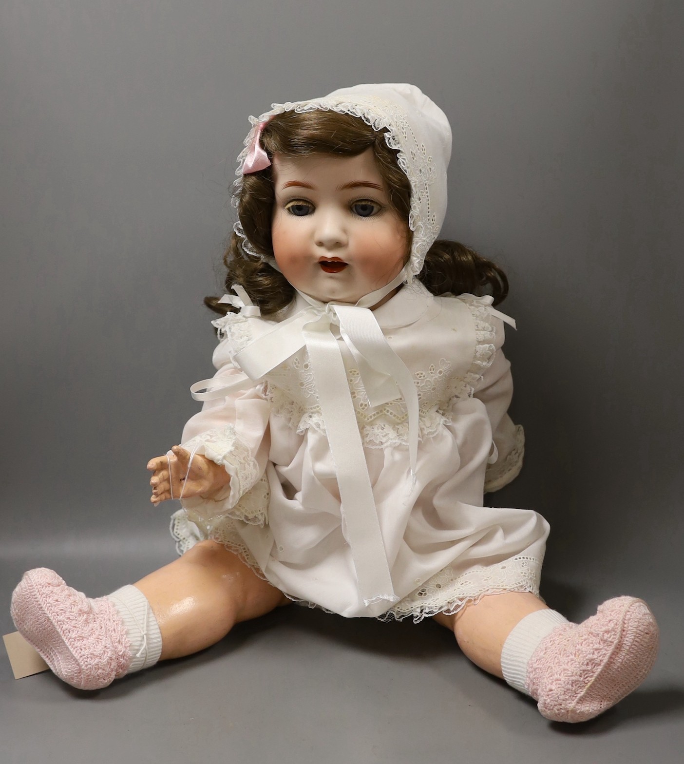 A Heubach Koppelsdorf bisque headed, open mouthed doll, 66cms long